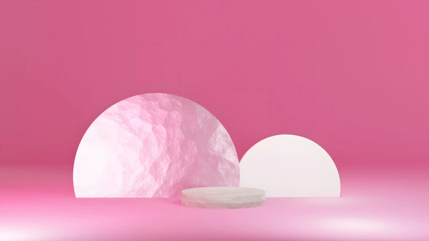 two white objects sitting in front of a pink wall