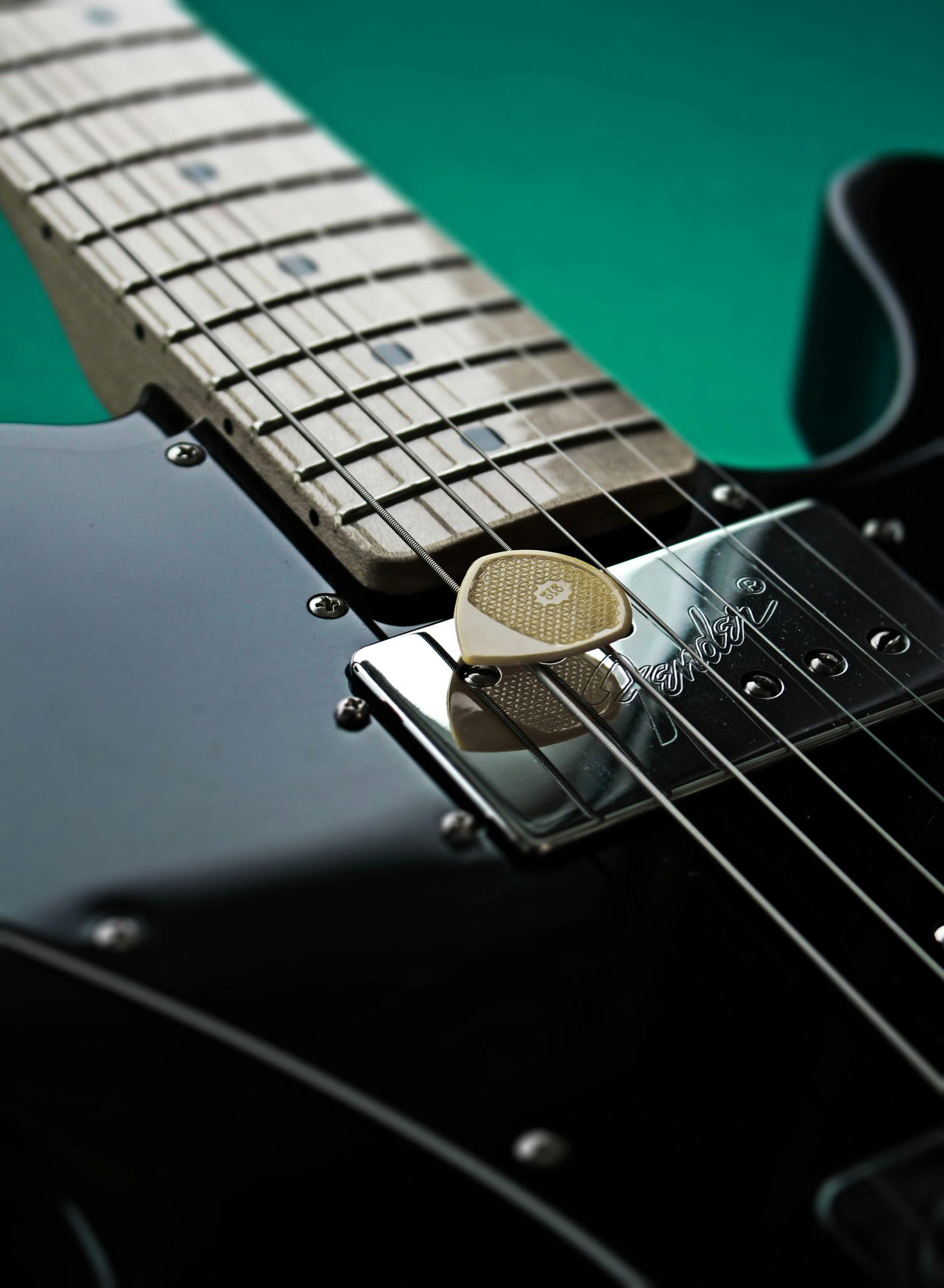 an electric guitar is sitting with a gold disc resting on it's fretset