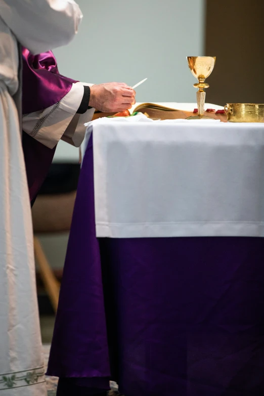 the priest is preparing for the ceremony