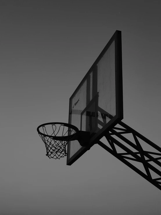 the silhouette of a basketball hoop and an empty basket