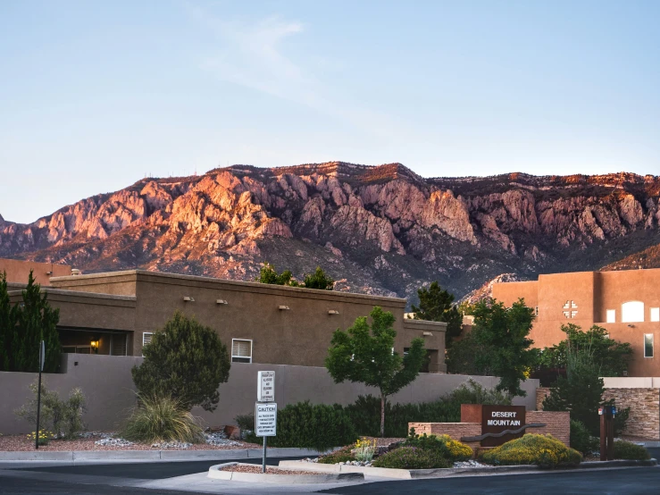 a street with mountains in the background at dusk