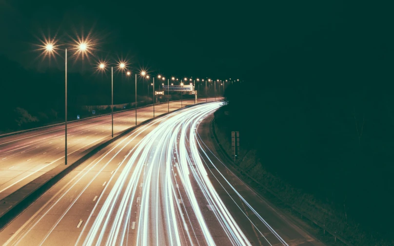 long exposure po of lights streaking over a street