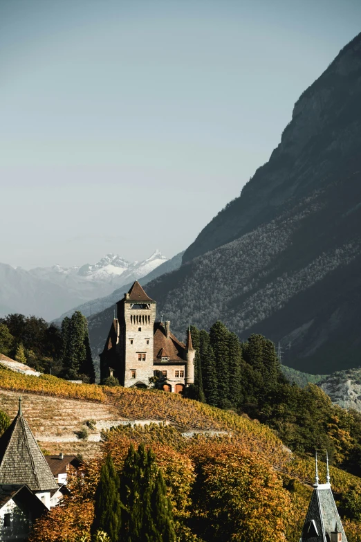 the building with tall steeps and a steep mountain range in the background