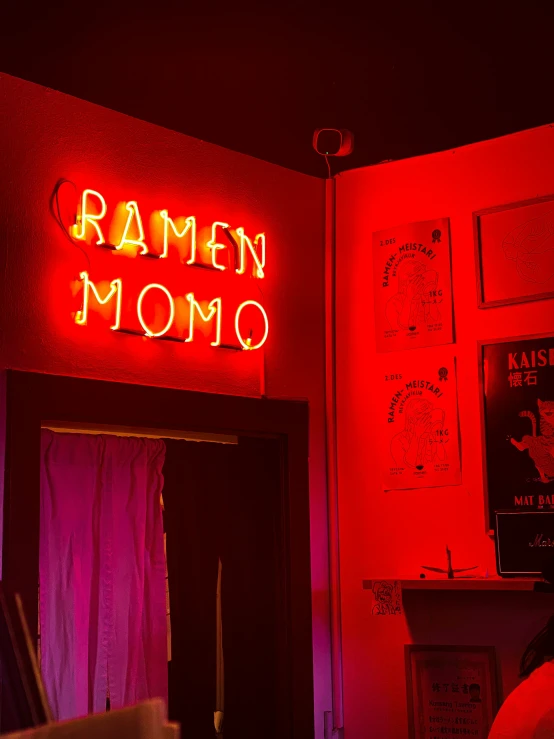 a red room with a neon sign above the door