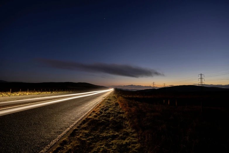 an empty street at dusk with dark clouds