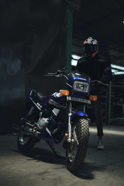 a man sitting on a black motorcycle with his bike