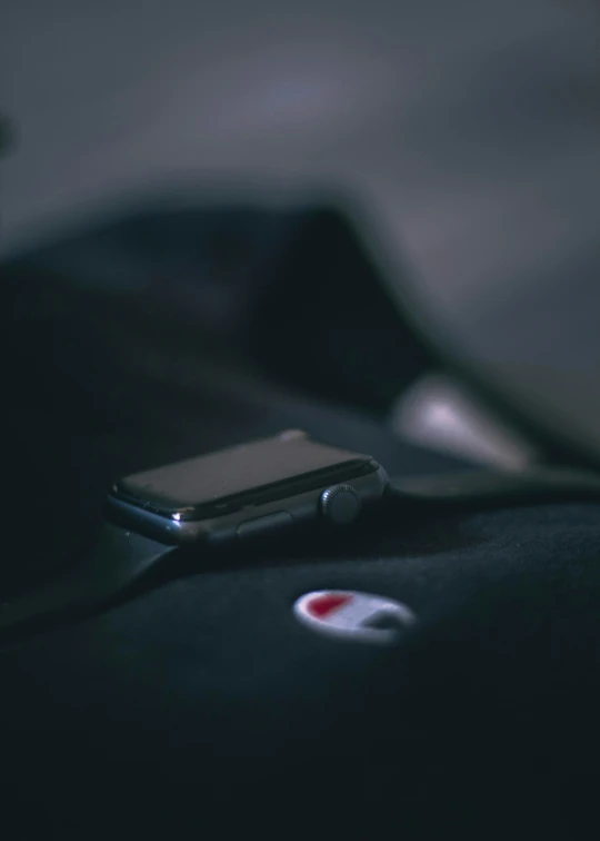 a phone with a red dot on its display on a couch