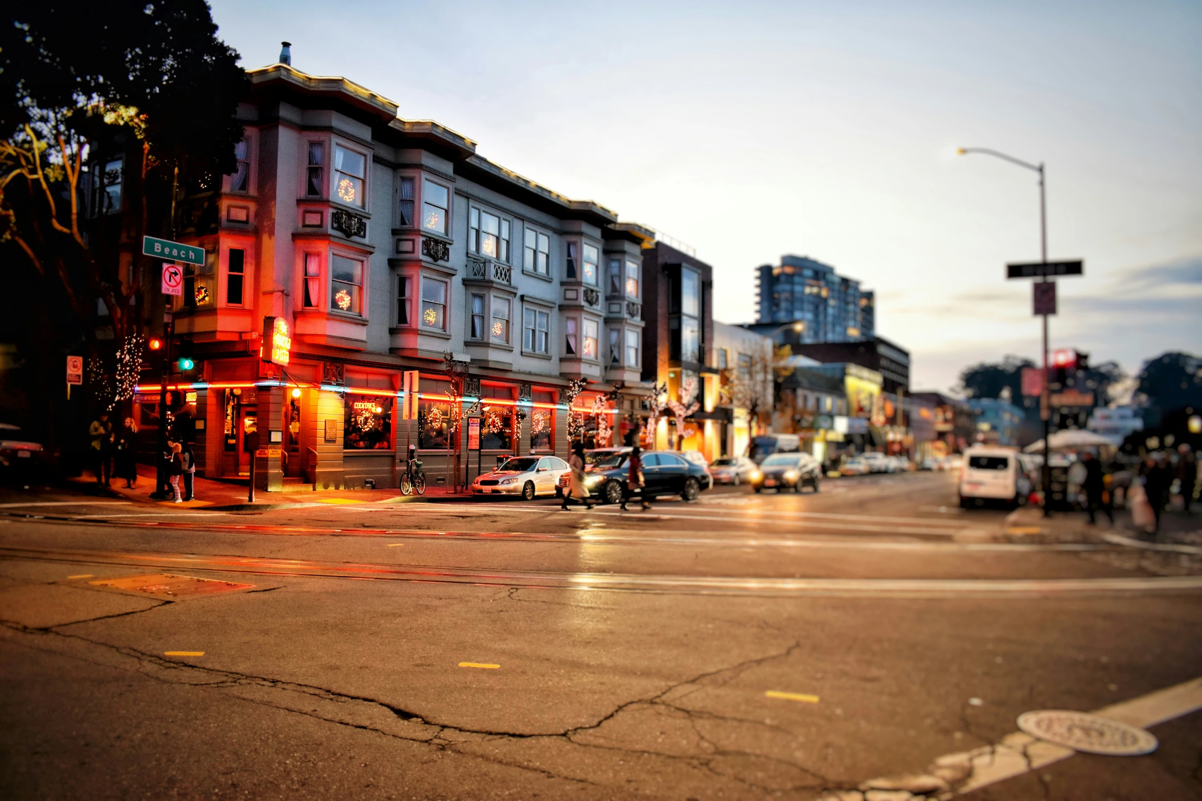 this is a downtown street intersection in the evening