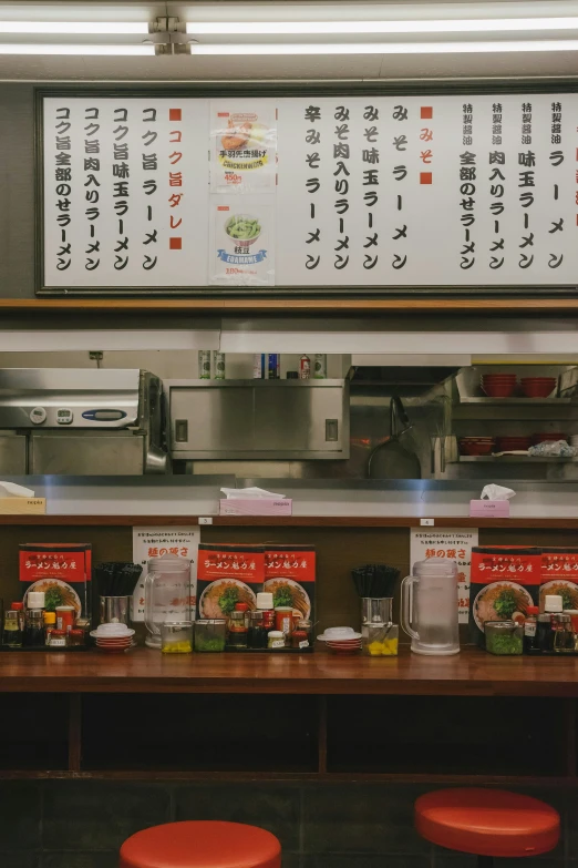 an asian menu above a japanese food counter