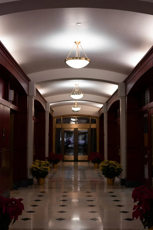 a long hall with two rows of lights on