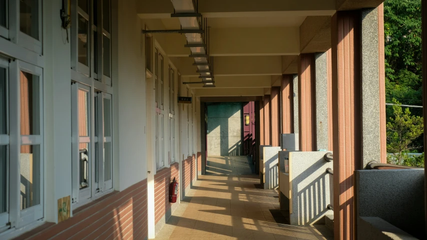 a long corridor with multiple windows and railings