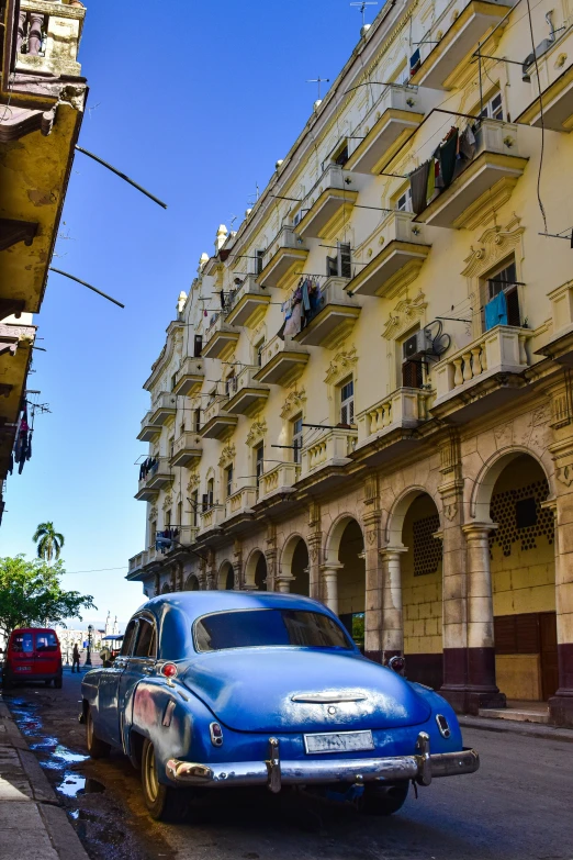 an old classic car on a narrow street