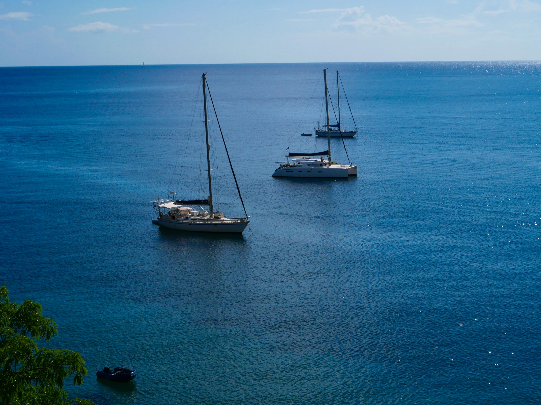 a number of sail boats in the ocean