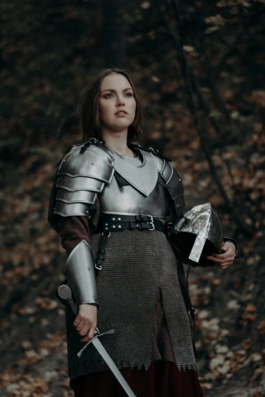 a woman dressed as a knight holding a sword