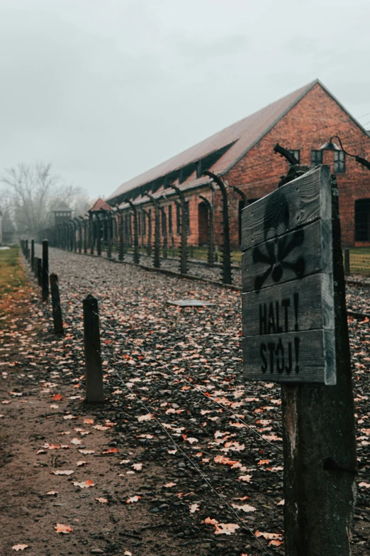 a sign on post at a brick building