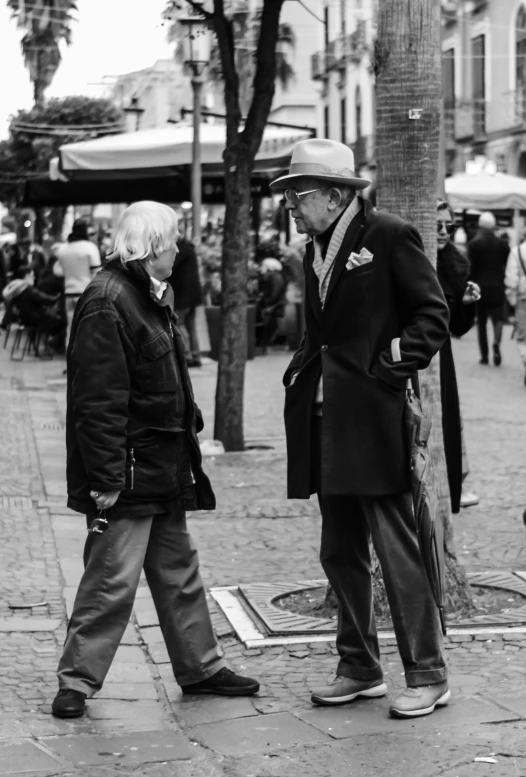 black and white po of older couple walking together on sidewalk