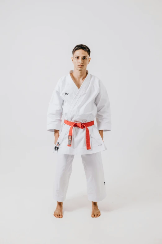 young man in white kimono posing for po