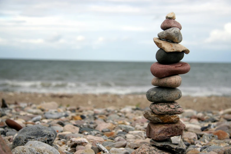 a pile of rocks with a rock tower next to it