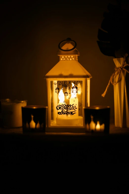 a lit candle in front of some candles on a table