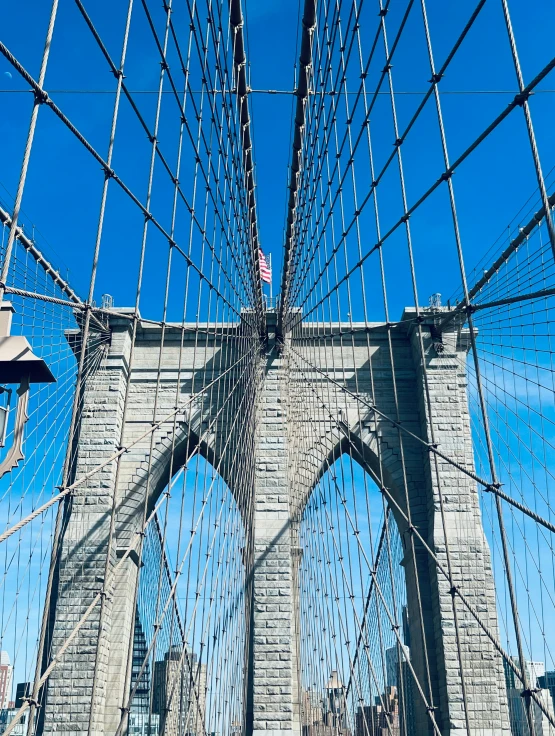 a person that is standing on the edge of a bridge