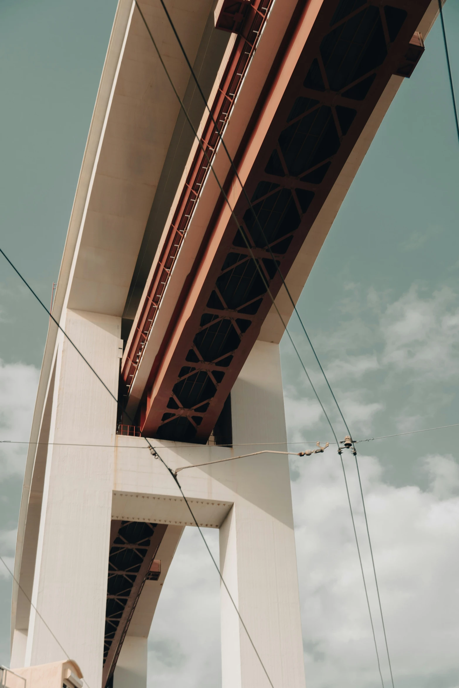 traffic light and wires on the side of a suspension bridge