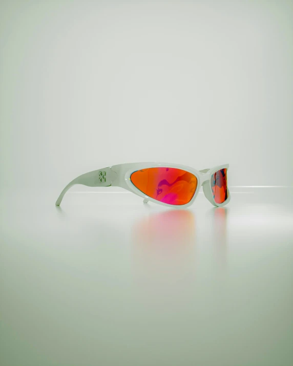 sunglasses with mirrored lenses sit on a surface