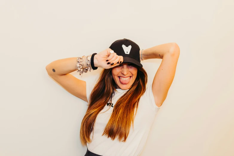 a woman posing with her hair in a hat