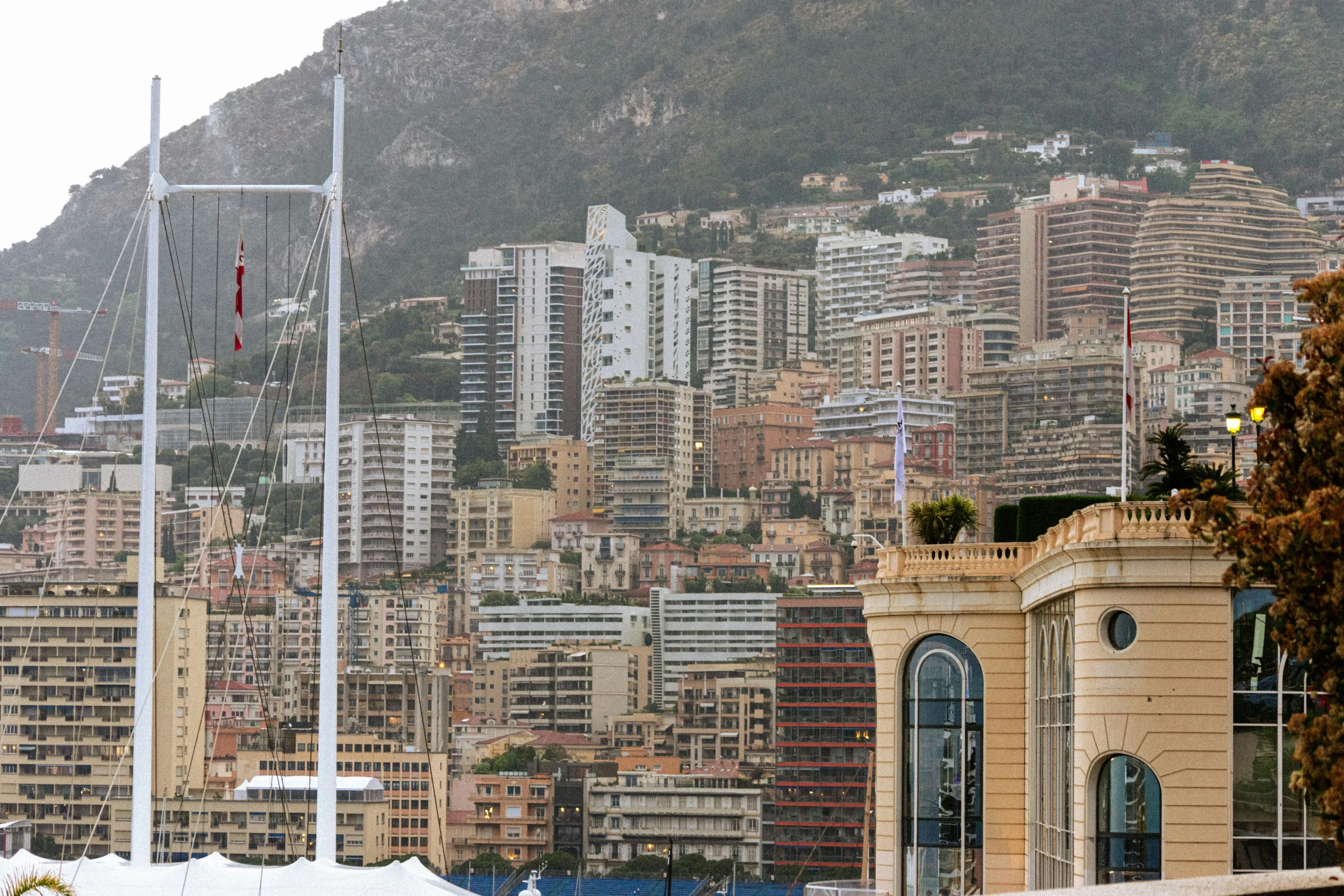 a boat sitting in front of a harbor next to tall buildings