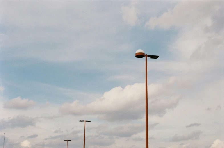 a parking lot with street lights and tall poles