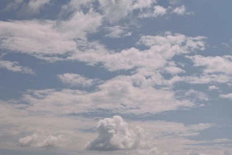 an airplane is flying high above the clouds