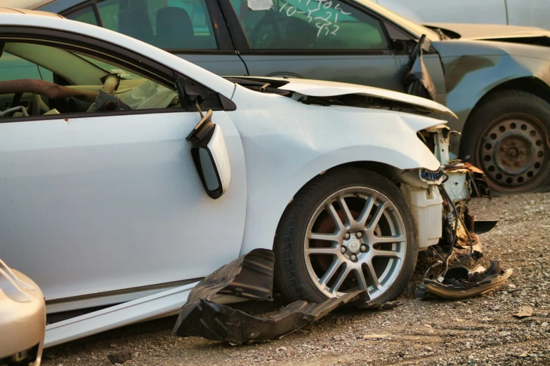 this is the front side of a white vehicle with a broken windshield