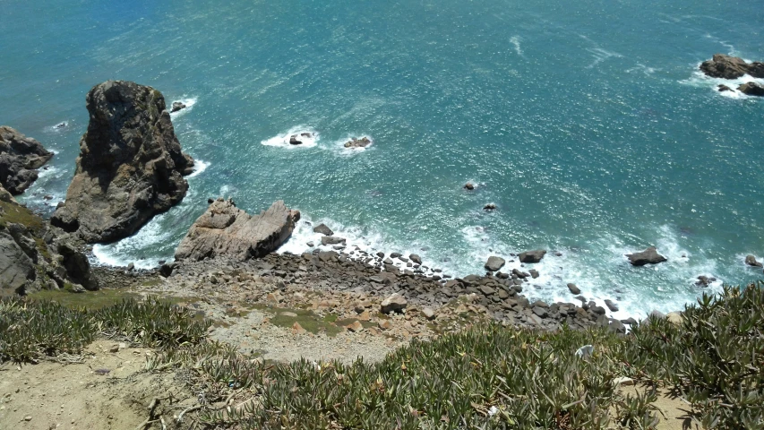 a view from a hill overlooking the water