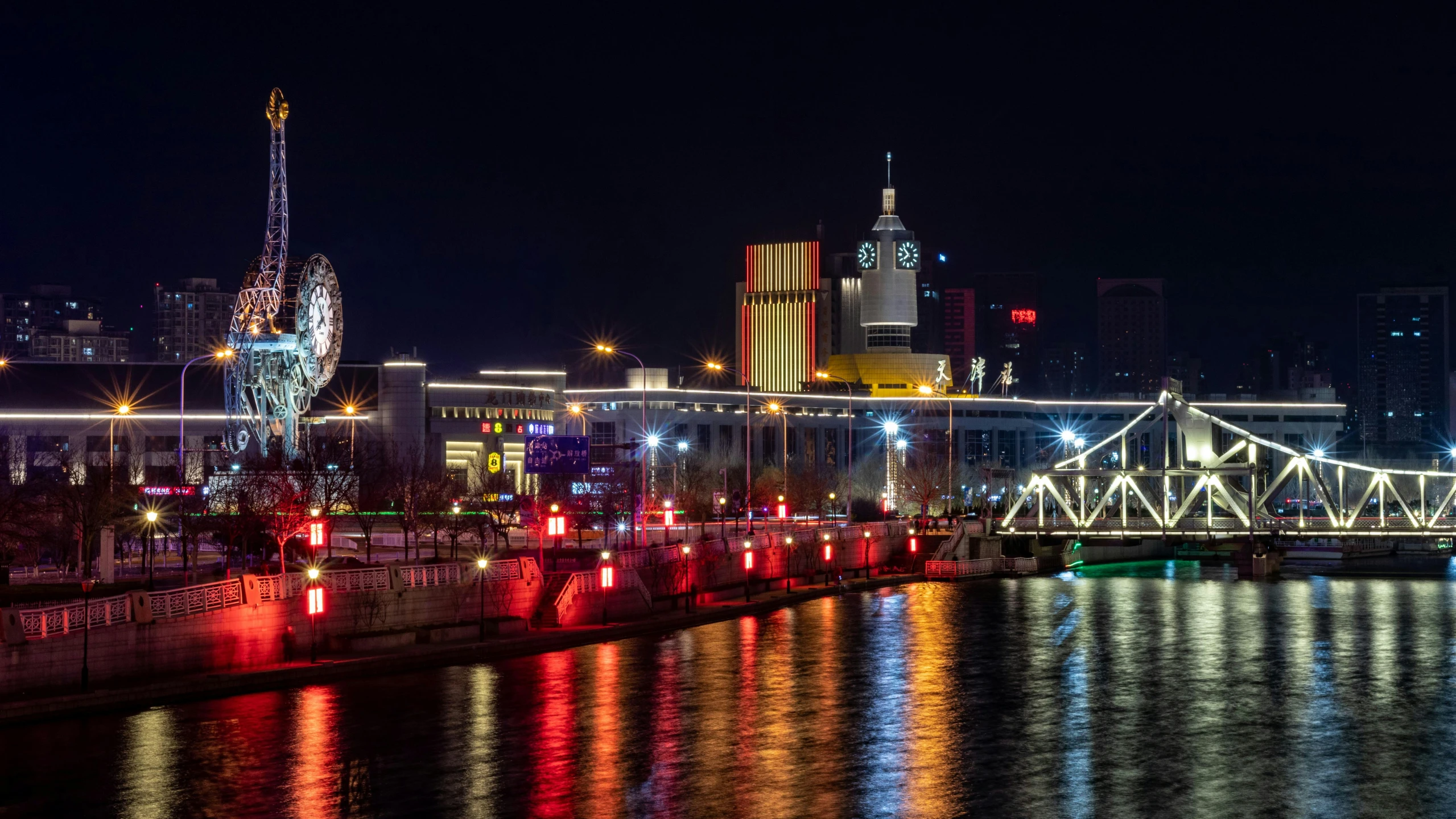 a cityscape lit up at night on the water