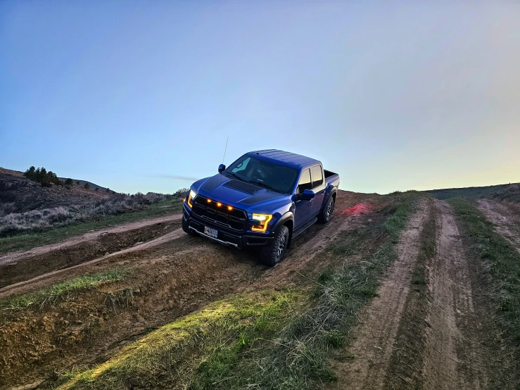 a suv traveling down a dirt road in the middle of nowhere