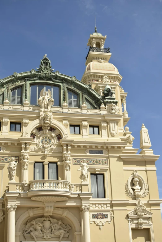 a tall building with a dome top and elaborate architecture