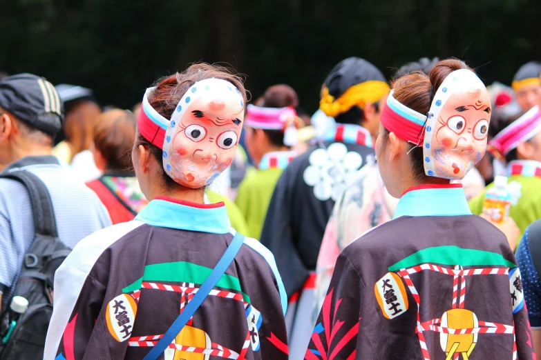 there are two people wearing colorful faces behind them