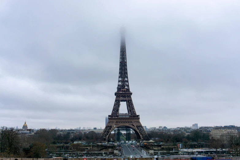 a train is near the base of the eiffel tower