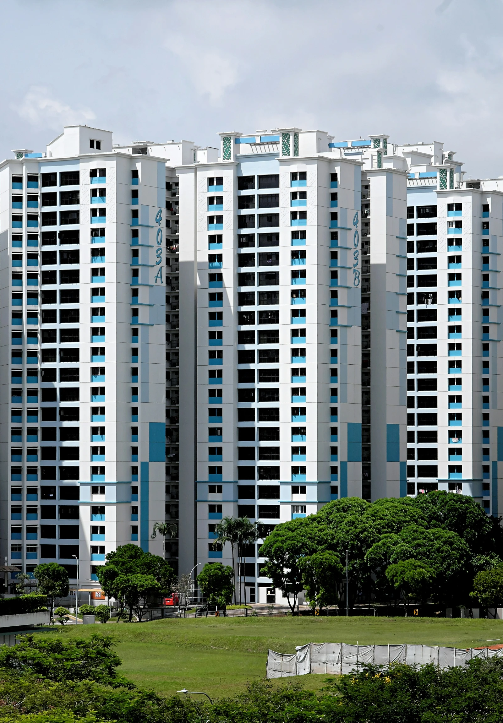 a row of building next to a green field