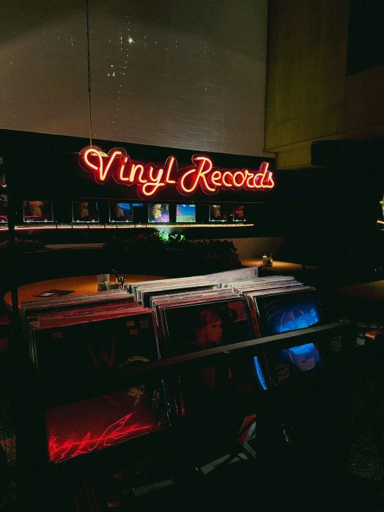 a neon sign that says vinyl records in the dark