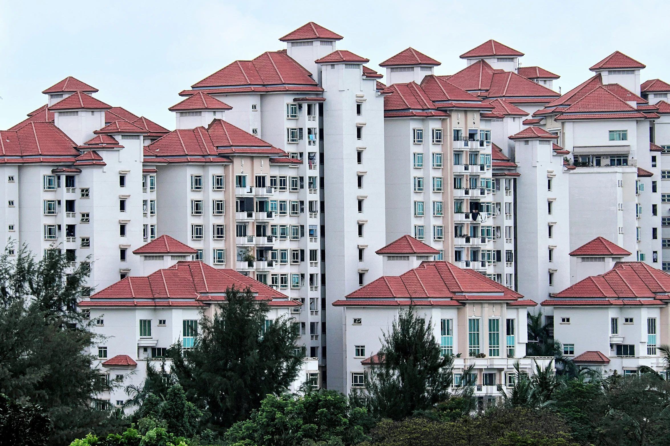 an odd architecture looking building with red roofs