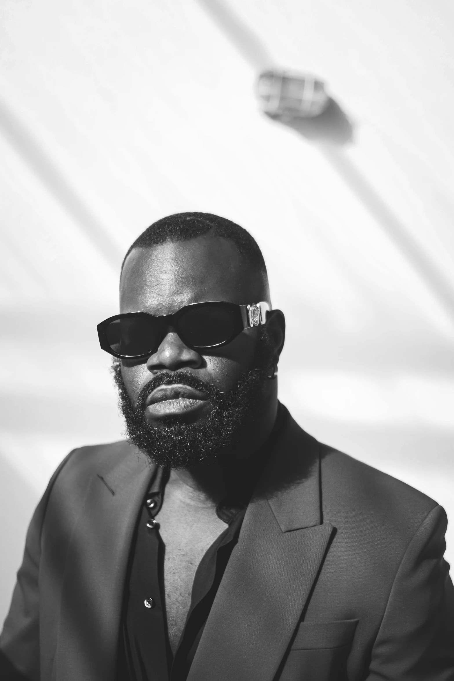 a black man wearing sunglasses and suit jacket