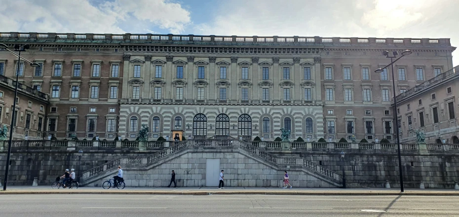 large stone building on street corner with lots of windows