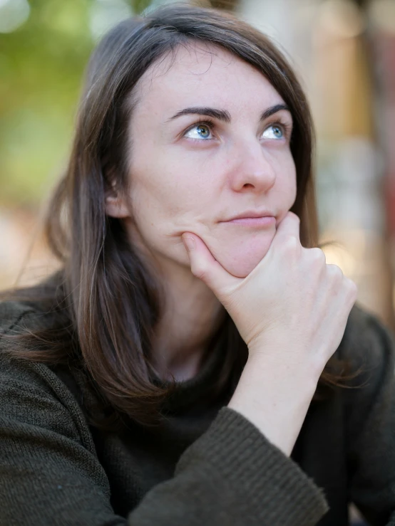 a woman is looking away as she stares