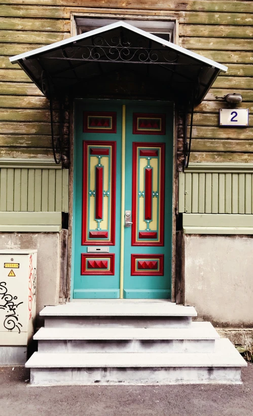 a large door sitting next to a set of steps