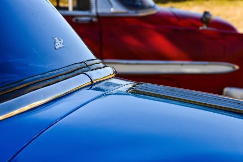 old cars are lined up in the grass