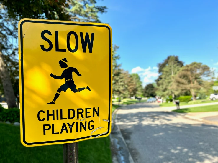 a slow children play sign on a wooden pole