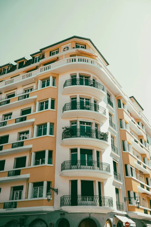 the apartment building with two floors is near two motorcycles