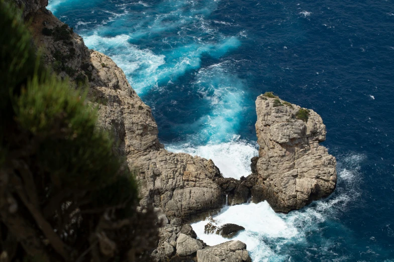 a rocky shoreline with choppy blue water