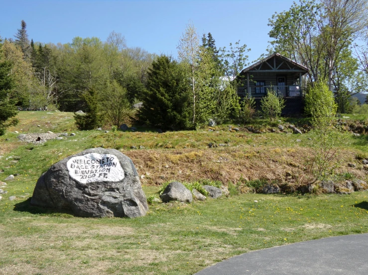 a sign for the town of wildrose sits in front of a house