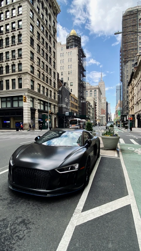 black car driving through busy city street in motion